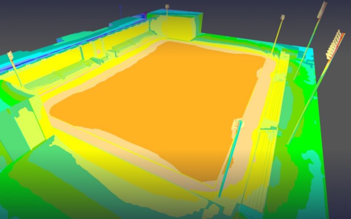 Colour-coded illuminance map of a floodlit stadium model: each colour is a lux band, with the pitch an even orange.