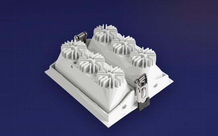 Rear view of an NLC MINI recessed downlight showing a finned aluminium heatsink behind each LED module.